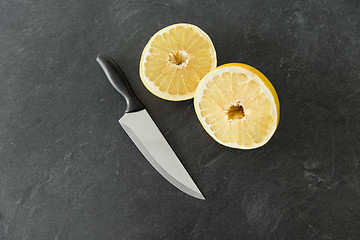 Image showing close up of chopped lemon and knife on table