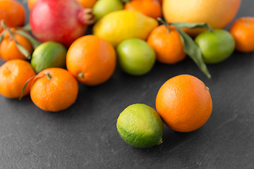 Image showing close up of citrus fruits on stone table