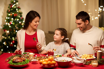 Image showing happy family having christmas dinner at home