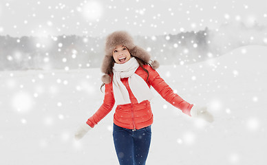 Image showing happy woman in winter fur hat having fun outdoors