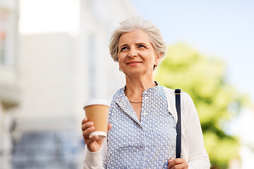 Image showing senior woman drinking coffee at summer city