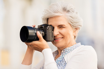 Image showing senior woman photographing by digital camera