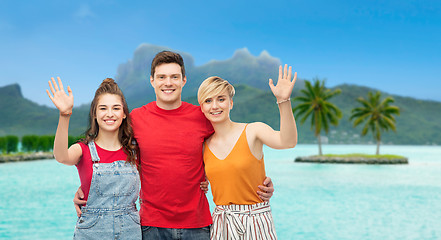 Image showing happy friends hugging over bora bora beach