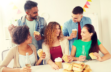 Image showing happy friends or team eating at office party