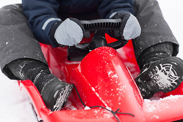 Image showing close up of boy driving sled in winter