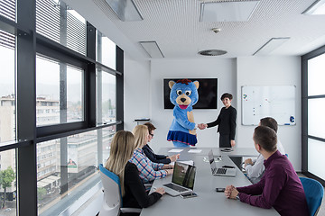 Image showing boss dresed as bear having fun with business people in trendy of