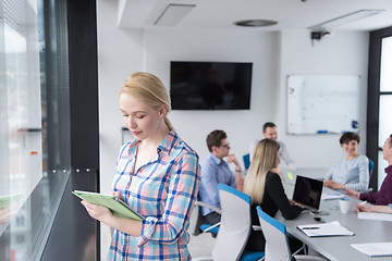 Image showing Pretty Businesswoman Using Tablet In Office Building by window