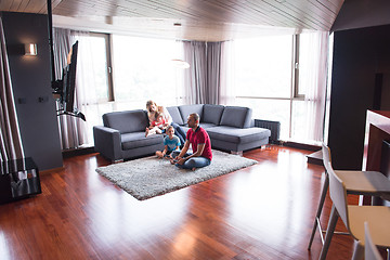 Image showing Happy family playing a video game