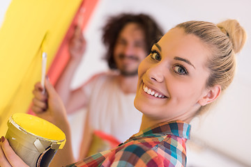 Image showing couple painting interior wall