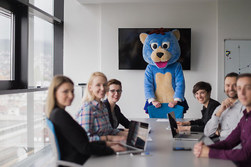 Image showing boss dresed as bear having fun with business people in trendy of