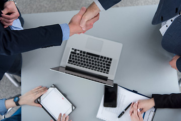 Image showing cloasing the deal in modern office interior top view