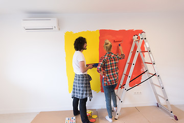 Image showing couple painting interior wall