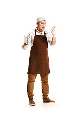 Image showing Smiling butcher posing with a cleaver isolated on white background