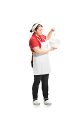 Image showing Portrait of cute smiling woman with bowl in her hands in the studio, isolated on white background