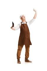 Image showing Smiling butcher posing with a cleaver isolated on white background