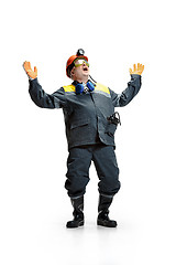 Image showing The studio shot of senior bearded male miner standing at the camera on a white background.