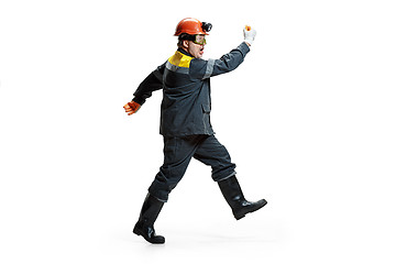 Image showing The studio shot of senior bearded male miner standing at the camera on a white background.