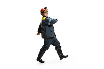 Image showing The studio shot of senior bearded male miner standing at the camera on a white background.