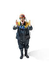 Image showing The studio shot of senior bearded male miner standing at the camera on a white background.