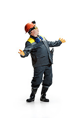 Image showing The studio shot of senior bearded male miner standing at the camera on a white background.