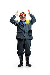 Image showing The studio shot of senior bearded male miner standing at the camera on a white background.