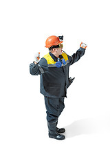 Image showing The studio shot of senior bearded male miner standing at the camera on a white background.