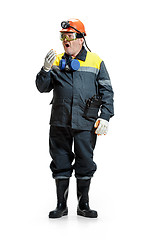 Image showing The studio shot of senior bearded male miner standing at the camera on a white background.