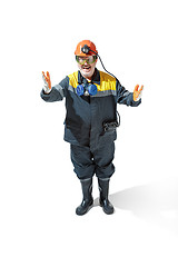 Image showing The studio shot of senior bearded male miner standing at the camera on a white background.