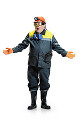 Image showing The studio shot of senior bearded male miner standing at the camera on a white background.