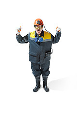 Image showing The studio shot of senior bearded male miner standing at the camera on a white background.