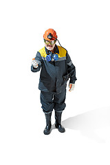 Image showing The studio shot of senior bearded male miner standing at the camera on a white background.