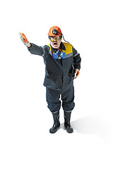 Image showing The studio shot of senior bearded male miner standing at the camera on a white background.