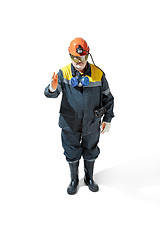 Image showing The studio shot of senior bearded male miner standing at the camera on a white background.