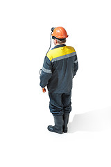 Image showing The studio shot of senior bearded male miner standing at the camera on a white background.