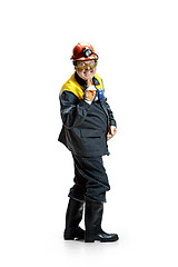 Image showing The studio shot of senior bearded male miner standing at the camera on a white background.