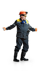 Image showing The studio shot of senior bearded male miner standing at the camera on a white background.