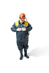 Image showing The studio shot of senior bearded male miner standing at the camera on a white background.