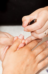 Image showing Laying nail polish on a woman\'s hands