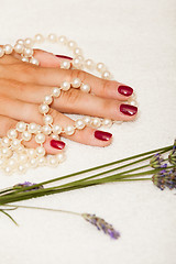 Image showing Hands of a woman with red nail polish posed by an esthetician