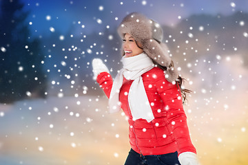 Image showing happy woman in winter fur hat having fun outdoors