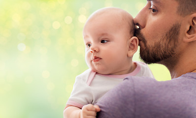 Image showing close up of father kissing little baby daughter