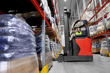 Image showing male loader operating forklift at warehouse