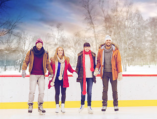 Image showing happy friends on outdoor skating rink