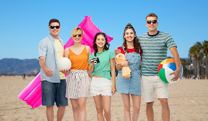 Image showing happy friends with beach and summer accessories