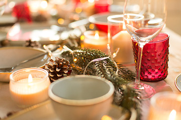 Image showing pine cone and candles burning on christmas table