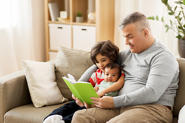 Image showing happy father with sons reading book at home