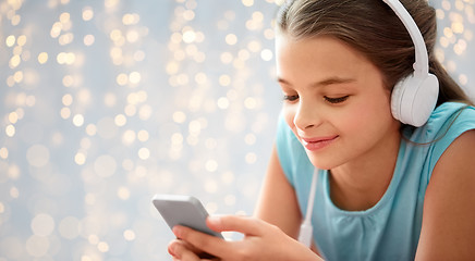 Image showing close up of girl with smartphone and headphones