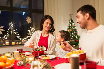 Image showing happy family having christmas dinner at home