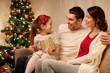 Image showing happy family with christmas present at home