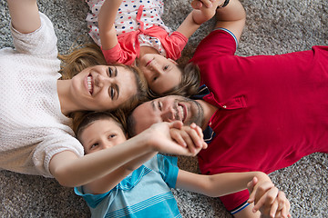 Image showing happy family lying on the floor